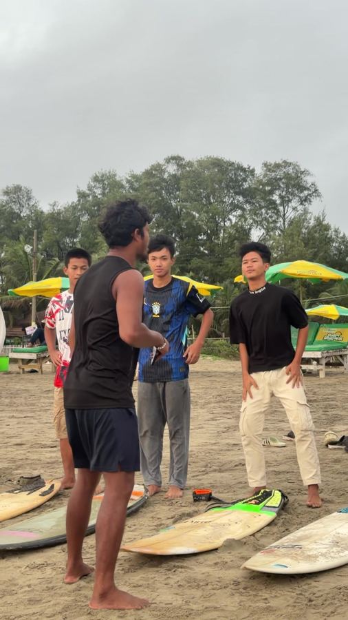 A coach teaching technique on the sand