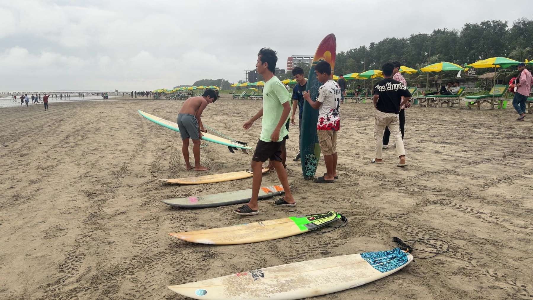 Students getting their boards ready for a lesson on Cox's Bazar beach