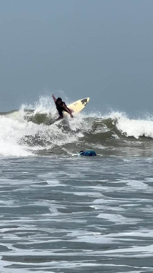A local surfer snapping off the top of a wave at Cox's Bazar